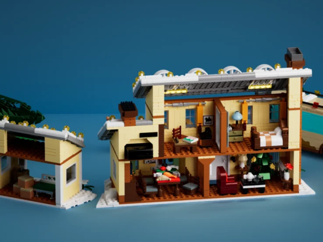 Ladder reaching the snowy roof of the holiday house model